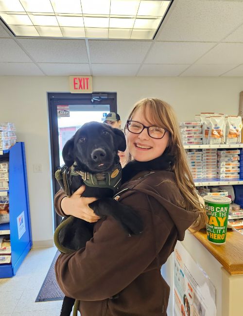 a vet holds a black dog